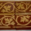 Minton Border tile apprx 6"by 2" in red with buff leaf design