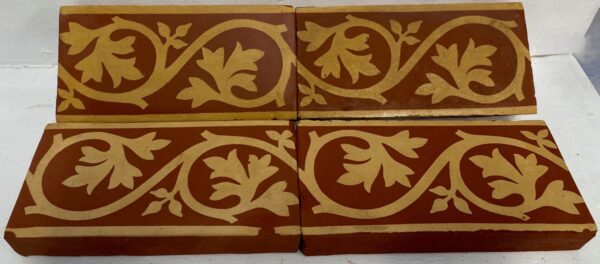 Minton Border tile apprx 6"by 2" in red with buff leaf design